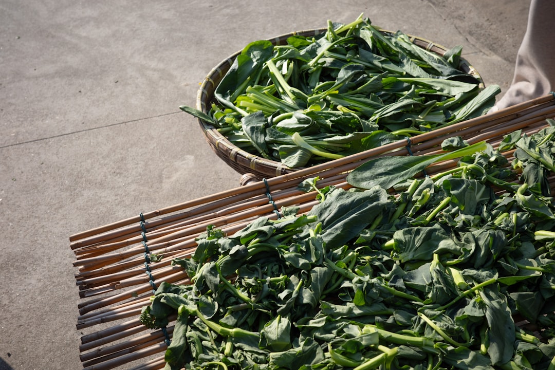Freshly harvested green vegetables in woven baskets.