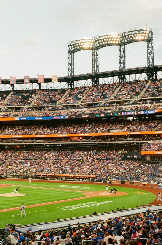 A baseball game in a crowded stadium under bright lights