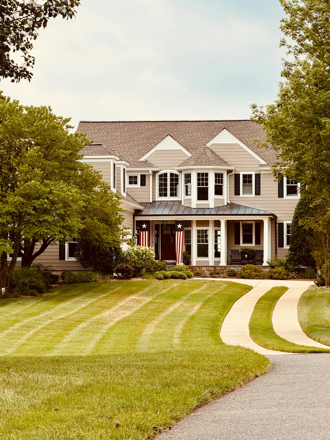 Large house with winding driveway and manicured lawn