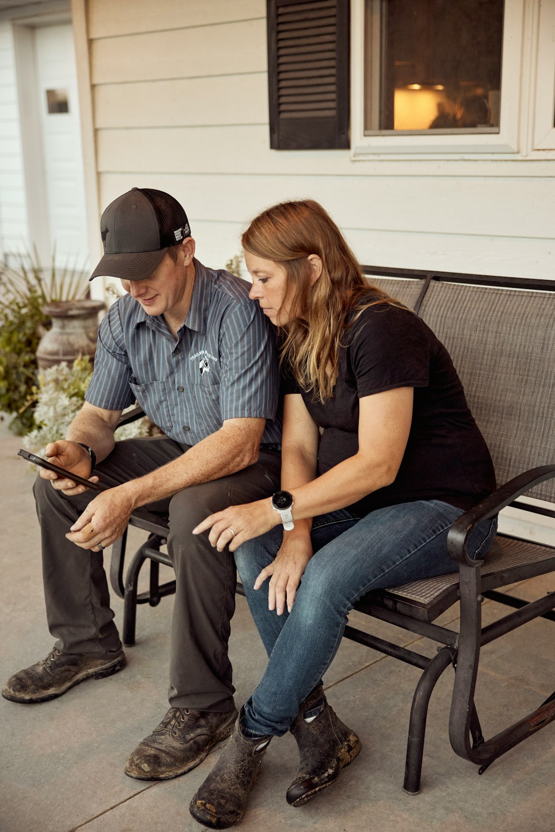 Two people sitting together on a porch